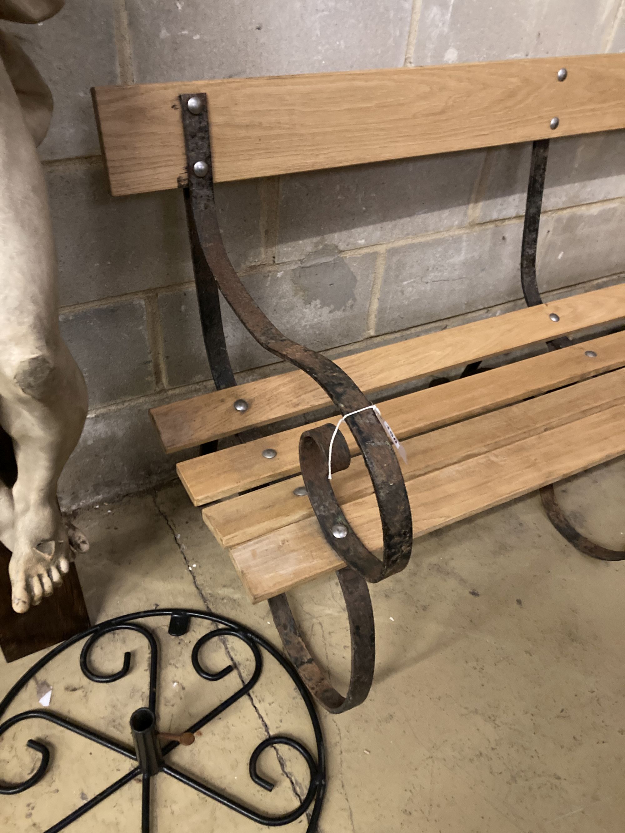 A wrought iron slatted wood garden bench, length 154cm, depth 54cm, height 83cm